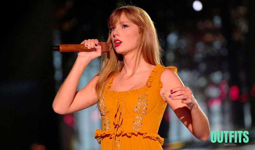 Taylor Swift wearing a yellow Etro dress during the Eras Tour 